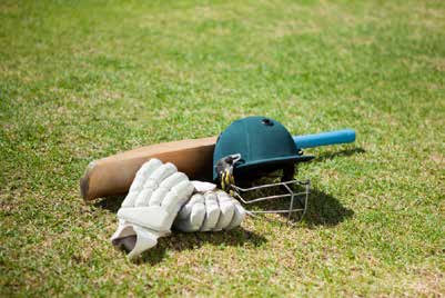 Cricket kit lying on ground by joyville